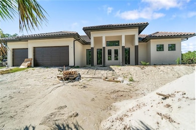View of front of house with french doors, a garage, stucco siding, and a tile roof