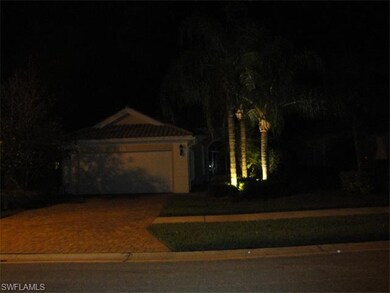 Property view at night with custom outdoor lightin