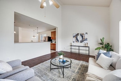 Living area with ceiling fan, wood finished floor
