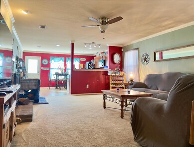 Living room with ornamental molding, carpet floori