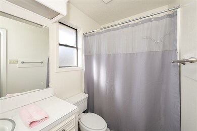 Full bath with toilet, a shower with shower curtai
