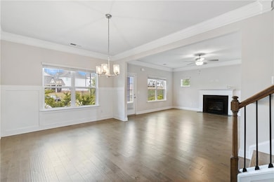 Unfurnished living room featuring ceiling fan with