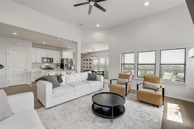 Living room featuring ceiling fan, recessed light