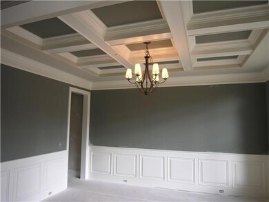 Coffer ceiling & transom windows, in Dining Room, which has a convenient attached Butler's Pantry/Wine Bar.