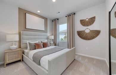 Bedroom featuring light colored carpet