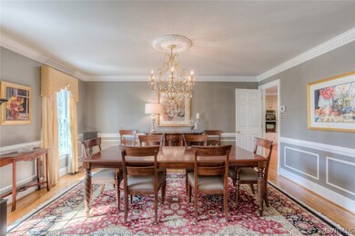 Large dining room with hardwood floors, dentil mou