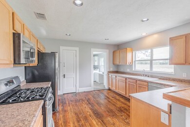 Kitchen has formica counters and walk in pantry