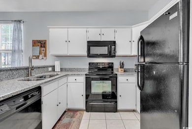 Kitchen with sink, light tile patterned flooring, 