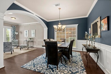 Very large formal dining room, crown molding, chair rail, hardwood floors, beautiful wall of windows to finish off the room.