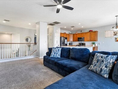 Living area with ceiling fan, light carpet, and re