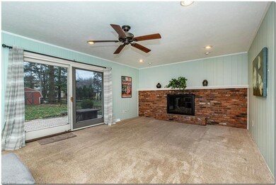 The large Family Room has               a fireplace and sliders leading to the patio