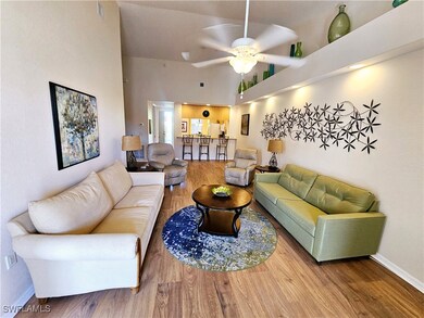 Living area featuring a towering ceiling, baseboar