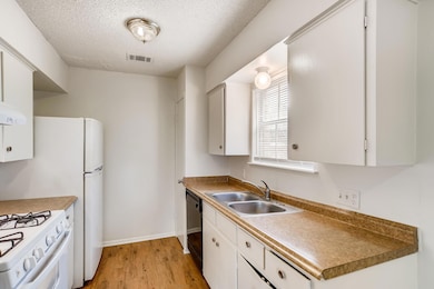 Kitchen featuring light wood finished floors, whi