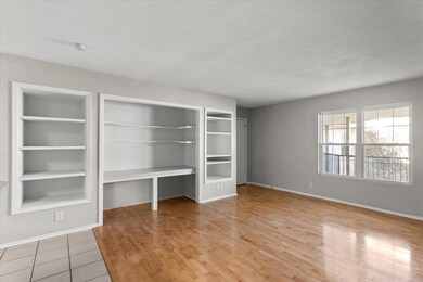 Unfurnished living room featuring light wood-style flooring and a textured ceiling
