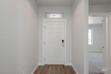 Foyer featuring baseboards and wood finished floors