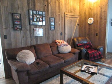 Additional living room space. Wood wall in living