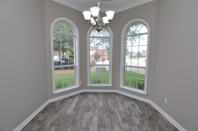 A large bay window and updated chandelier allows f