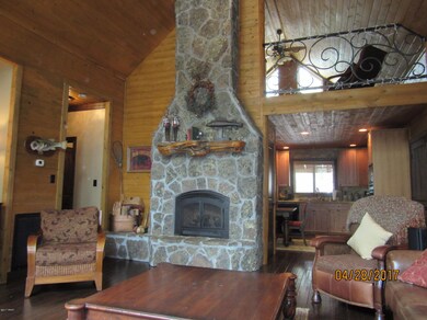 Fireplace with view to loft and kitchen