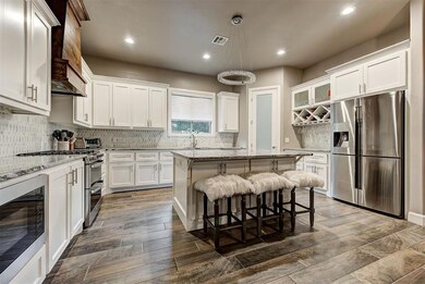 Kitchen with large island and stainless steel appl