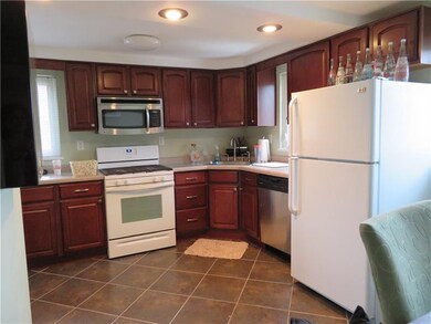 Large ceramic tile flooring with custom cherry cab