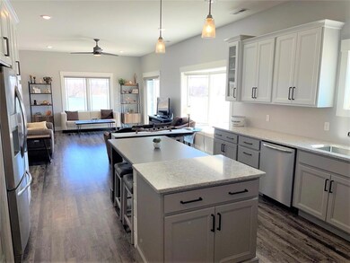 Kitchen With Breakfast Bar and Pendant Lighting