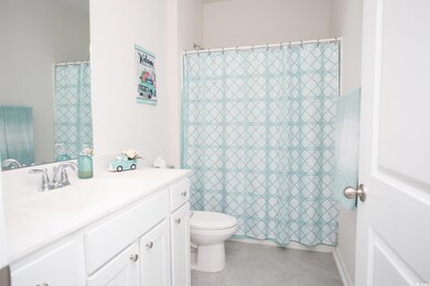 Bathroom with tile patterned floors, walk in showe