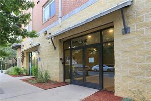 Property entrance featuring brick siding
