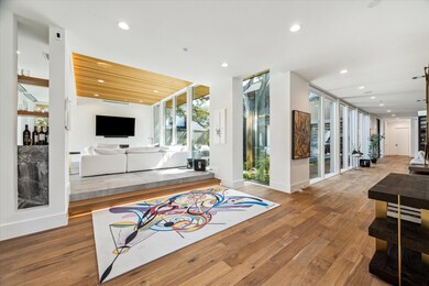 A striking entrance welcomes you with warm wood fl