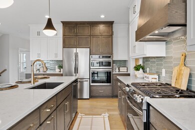 The heart of the home, the kitchen, features a spacious island that's perfect for meal prep, casual dining, and socializing. Complete with a sink, the island adds convenience to culinary endeavors.