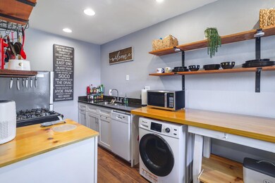 Kitchen featuring washer / dryer, stainless steel