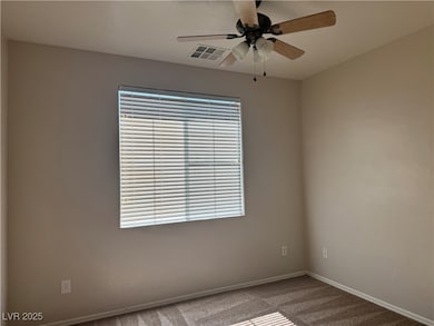 Spare room featuring ceiling fan and carpet floors