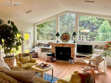 Living room featuring hardwood flooring, lofted ce