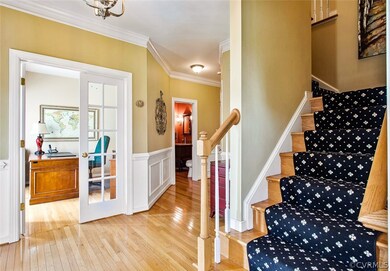 Foyer view to office, full hall bath and stairs