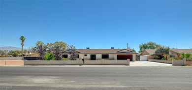 Ranch-style house featuring concrete driveway and a garage