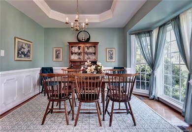 Formal Dining Room with hardwoods, tray ceiling and moldings.