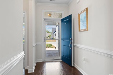 Foyer entrance with dark hardwood / wood-style flo