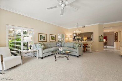 Carpeted living room with ceiling fan with notable
