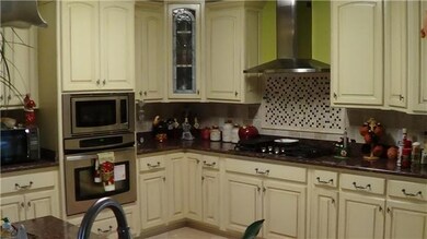 Granite countertops and travertine floors in this dream kitchen.
