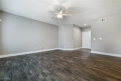 Empty room featuring dark wood-style flooring, a c