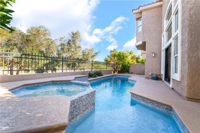 View of pool with a pool with connected hot tub an