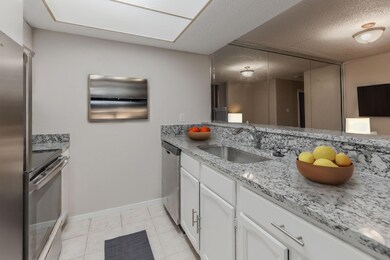 Living room with a tile fireplace and light hardwo