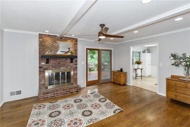 Cozy hearth room opens to the backyard and kitchen