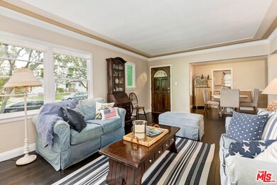 Living room towards front door and dining area.
