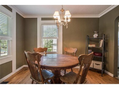 The dining room features hardwood floors, wide cro
