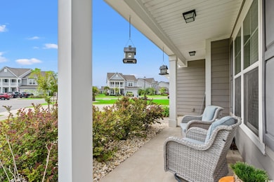 Covered porch featuring a residential view