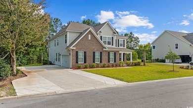 Craftsman-style home featuring brick siding, driveway, a front lawn, and a shingled roof