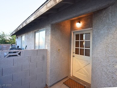 Entrance to property featuring stucco siding