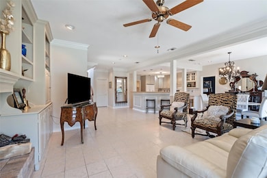 Living room featuring visible vents, light tile p