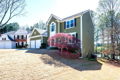 View of front facade with driveway, a garage, and 