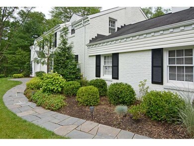 Exterior Front. Pretty landscaping lines the stone